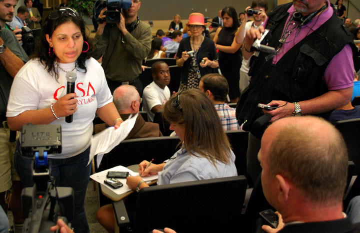 Activists flood into hearing on deportation program, confront official