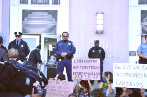 Protesters sit on the steps of the Henry J. Daly building in Washington, awaiting entry to the police department to file witness statements.