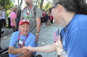 World War II veterans were greeted by volunteers and lawmakers as they entered the memorial. (Elena Schneider/Medill News Service)