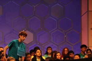 Thomas Manning, 14, heads up to the microphone from his seat Wednesday morning.  Thomas dealt with nerves by chatting with the pronouncer. (Anna Bisaro/MNS)