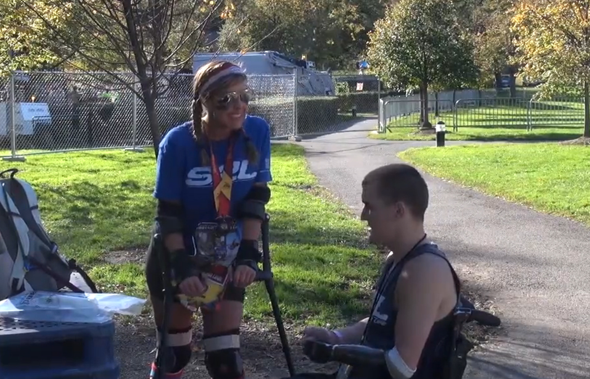 Woman finishes marathon on crutches, honors disabled Marine boyfriend