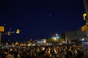 A police helicopter circles protesters as the 10 p.m. curfew approaches.