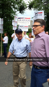Rick Perry bumps into fellow presidential hopeful Lindsey Graham at a parade in New Hampshire.