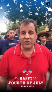 Chris Christie takes a moment to address the camera at a parade in New Hampshire.