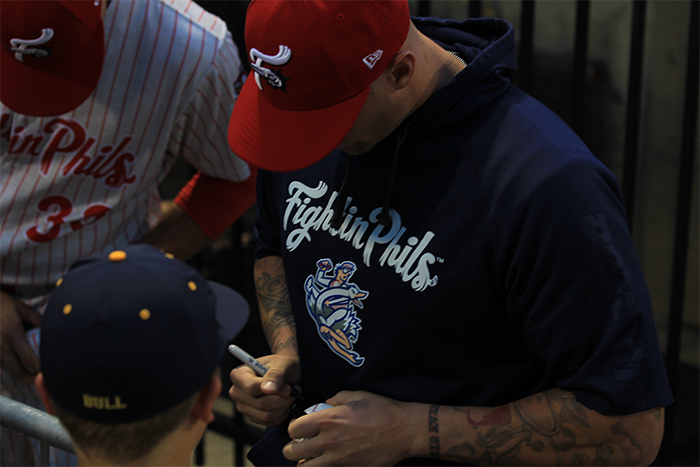 Nick Rickles signing autographs before the game.