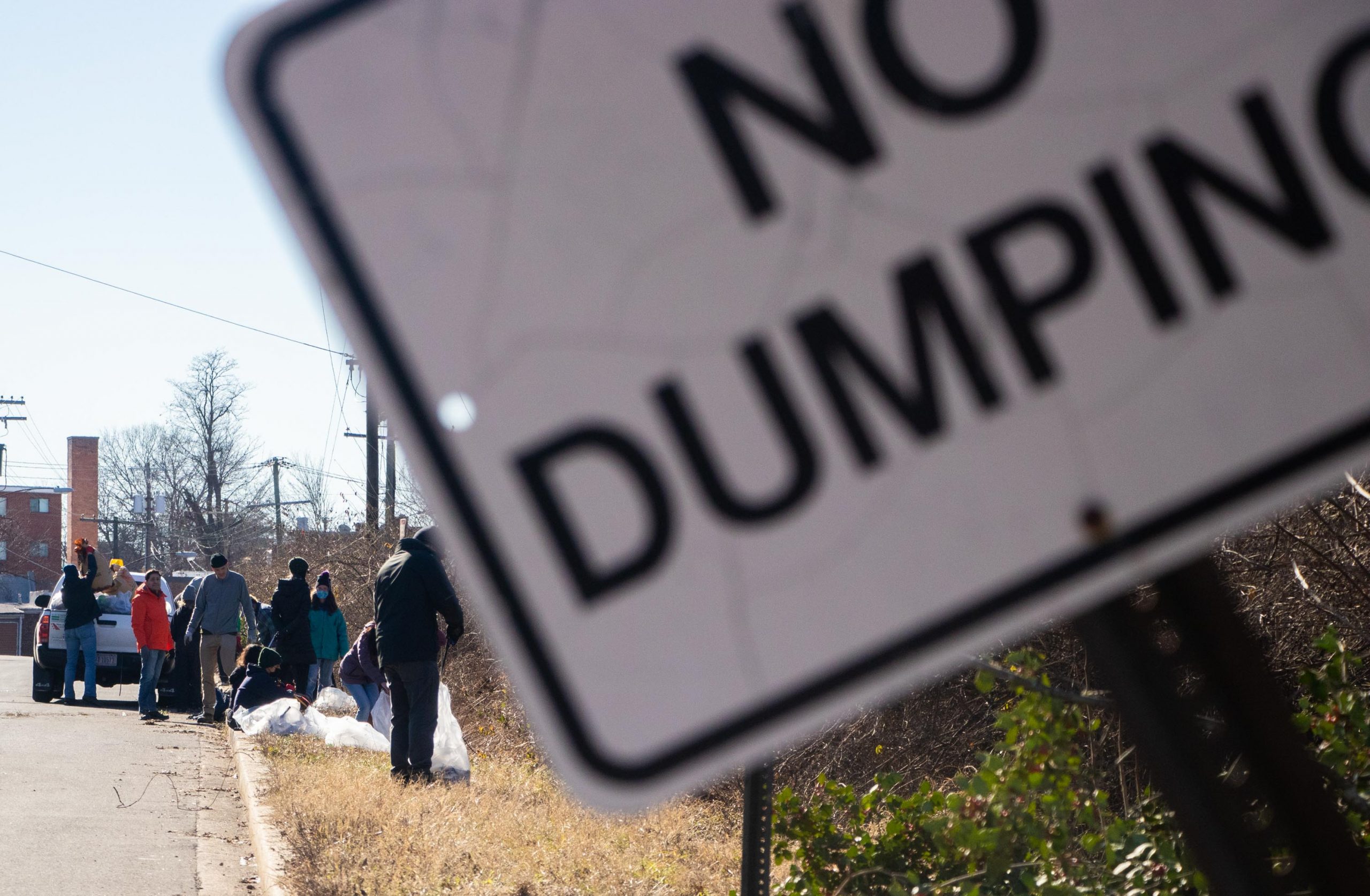 Volunteers search for trash alongside the street Saturday during the Martin Luther King day of service cleanup on Saturday. Pope Branch Park is sometimes used as an illegal dumping site according to Trey Sherard of Anacostia RiverKeeper. (Isabel Miller | Medill News Service)