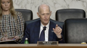 A close-up of Rick Scott at the committee hearing. He is pointing at the witnesses as he talks.